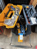 View of Ryobi and Black & Decker detail sanders and sanding supplies inside tool case