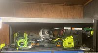Overview on shelf showing string trimmer powerhead, hybrid pump and attachments