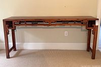 Full front view of console table showing overall proportions, carved apron details and leg frames.