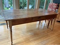 Full view of table showing overall shape, turned legs and single drawer