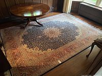Full view of the rug in a room setting showing overall pattern and condition.