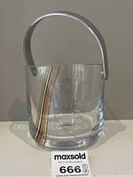 Front view of clear glass ice bucket showing rainbow swirl pattern with silver handle