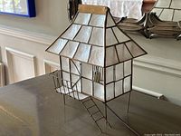 Side angled photo showing the entire vintage shell lamp in the shape of a house with brass frame and shell roof and walls, plus a balcony and ladder detail.