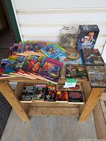 Overview of lot showing Goosebumps books, various paperback novels, Jewel Quest games, Horatio Hornblower DVD set, Mystery Masterpiece game, and model railway parts.