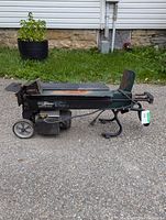 Side view of the Yard Works electric log splitter showing motor, wheels, and splitting wedge.