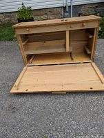 Chest front with door open revealing internal compartments and shelving for tool organization.