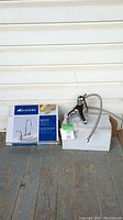 Glacier Bay KF2001 bar faucet set with box and manual on porch floor