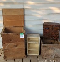 Photo showing four wooden storage items: a large box with lid opened, a small painted wooden shelf, a vintage CleanBeurre Canada wooden box inside a crate, and a small saw-marked wooden box on top.