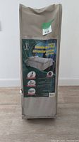 Beige carrying case upright with clear window label showing Ultimate BYO Bed branding and product information.
