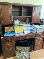 Front view of desk with hutch and storage drawers, contents on surface not included