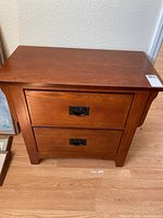 Front and top view of the wooden side table with two drawers showing medium brown finish and metal drawer pulls.
