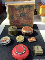 Antique and vintage collection including ornate box and assorted tins and stamp holder.