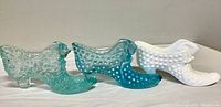 Set of three Fenton art glass slippers with cat head designs, clear blue, opaque white, and deep blue colors.