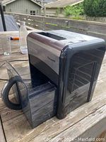Side angle showing the ValuLine desktop paper shredder with its pull-out bin partly open, highlighting the black and silver design.