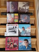 Top view of eight vinyl records arranged in two rows, showing Elvis Presley albums and a Wardell Gray jazz album, with visible record sleeves.