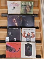 Eight vinyl records displayed in their sleeves, showing front cover artwork and artists, arranged in two rows of four.