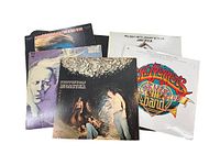 Five classic rock vinyl LP albums arranged with covers visible including Sgt. Pepper's, American Woman, Steppenwolf Monster, Johnny Winter's Second Winter and Jim Croce's You Don't Mess With Jim.