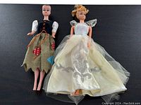 Both dolls side by side on black background