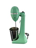 Front side view of the green vintage Hamilton Beach Drink Master malt mixer with stainless steel mixing cup. The mixer has a rounded head, and the stainless cup is placed on the base with a whisk attachment inserted into the cup.