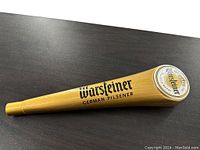 Top view of the tap handle showing the rounded end with Warsteiner emblem logo