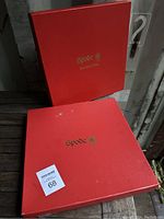 Two red boxes labeled Spode with gold logos. Boxes show signs of wear and damage.