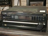 Front view of the Pioneer VSX-07TX stereo receiver showing the brand, model, and control panel with volume dial and display.