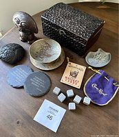 Full lot includes hammered metal box, pottery, coasters, whiskey rocks, whiskey cards, and Crown Royal pouch.
