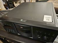 Front and top view of the Sony DVD disc changer unit showing the overall condition and control panel layout.