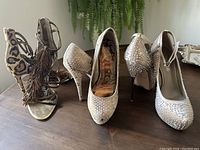 Three pairs of women's stilletto high heels shown from the front, middle, and back.