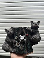 Front view of the small decorative plant pot showing two bears on either side of a tree trunk with flowers and a white mouse detail.
