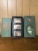 View of three cassette tapes in black plastic tray inside Lynyrd Skynyrd box case with stylized design and text.