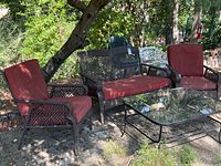 Full view of Pacific Bay outdoor settee, two chairs, and glass table on patio showing arrangement and condition.