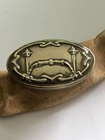 Oval silver plated Art Nouveau style box lid with floral and ornamental design, showing tarnish and wear.