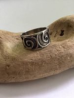 Front-facing photo of the vintage sterling silver ring with scroll design showing pattern and oxidized detailing.
