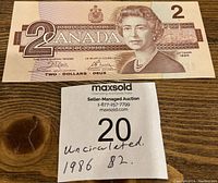 Front of the 1986 Canadian $2 banknote with Queen Elizabeth II portrait and '2 CANADA' denomination.