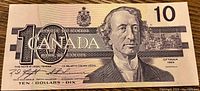 Front side of the 1989 Canadian $10 bill featuring Sir John A. Macdonald portrait and legal text.