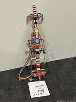 Front view of vintage Maasai beaded neck or chest piece with colorful beads, circular motifs, metal charms, and braided loops.