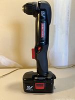 Front view of the Craftsman right angle drill showing brand, 3/8 inch chuck, and battery attached.