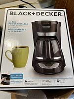 Box of Black & Decker 12-cup programmable coffee maker showing features and branding.