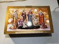Box of the Spirit of the Season porcelain nativity set showing all figures arranged with lighting effects on the packaging.