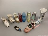 Top-down photo showing all 10 decorative boots in a row on a white background.