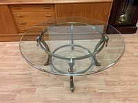Full view of round glass top on brass frame base