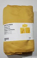 New NATTJASMIN fitted sheet in golden color for Full/Double beds, wrapped in packaging with label indicating size and brand.