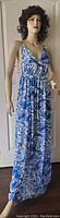 Full view of the blue and white floral and paisley print halter maxi dress on mannequin