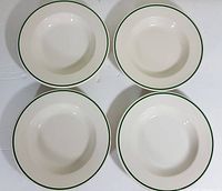 Top-down photo showing all four white ceramic soup bowls with green rim in a 2x2 layout on a white surface.