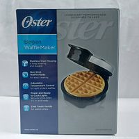 Box showing Oster Belgian Waffle Maker with features listed such as stainless steel housing, non-stick waffle plates, adjustable temperature control, power and ready to cook lights, and cool touch handle.