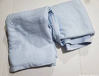 Folded bedspread showing color and waffle weave texture