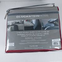 Packaged GlucksteinHome Davenport 3-piece duvet cover set with product details and images showing duvet and shams on bed.