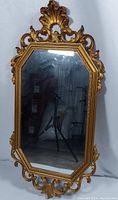 Full view of the vintage Syroco golden wall mirror with octagonal mirror and ornate frame.