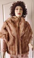 Front view of the vintage Eaton's fur wrap displayed on a mannequin. Shows full coverage of the fur wrap, texture, color and length.